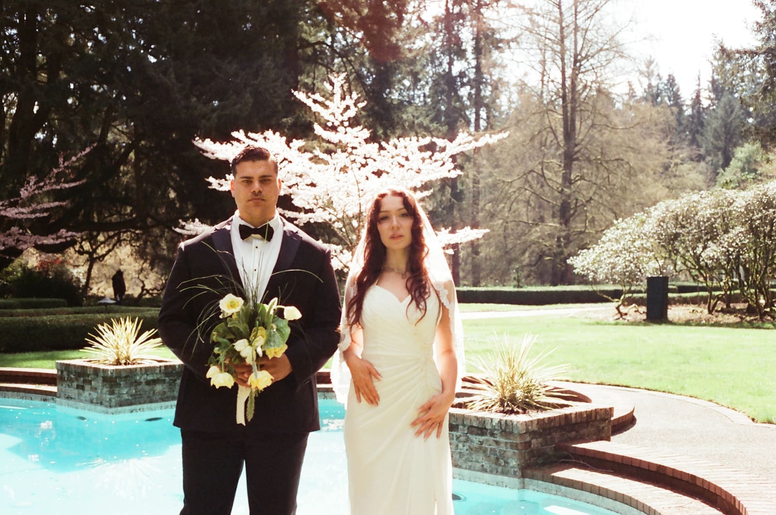 Carly and Gary photographed on CineStill 400D near the Lakewold Gardens pool.