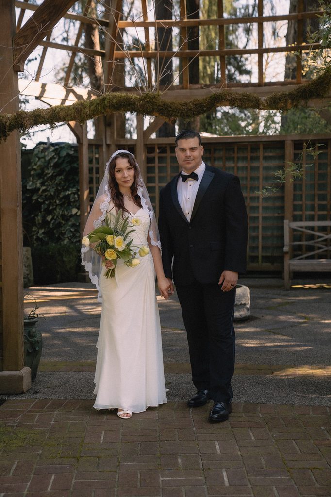 Couple posing in the Tea House Gazebo for their Lakewold Gardens wedding photos in Lakewood, WA.