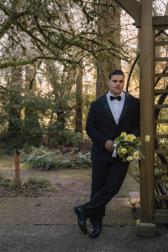 Groom posing against the Tea House Gazebo for his Lakewold Gardens wedding photos in Lakewood, Washington.