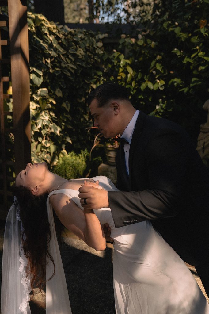 Groom dipping his bride back during portraits.