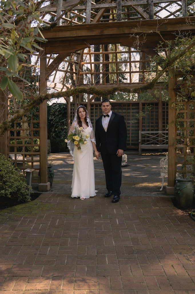 Bride and groom posing in front of the Tea House Gazebo at Lakewold Gardens wedding venue in Washington. 
