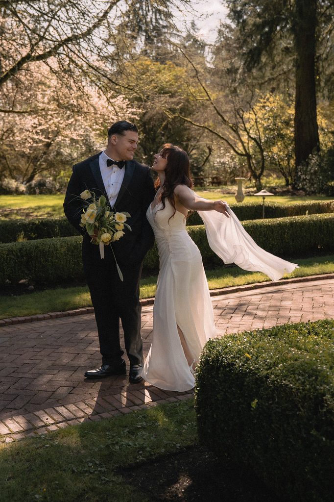 Couple posing in the gardens for their Lakewold Gardens wedding photos in Lakewood, Washington.