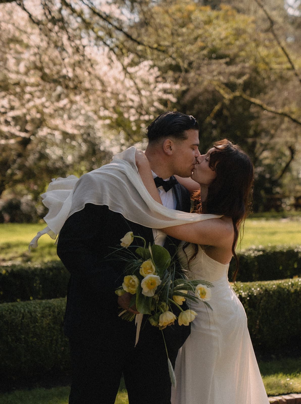 Bride and groom kissing during their Lakewold Gardens wedding photos.