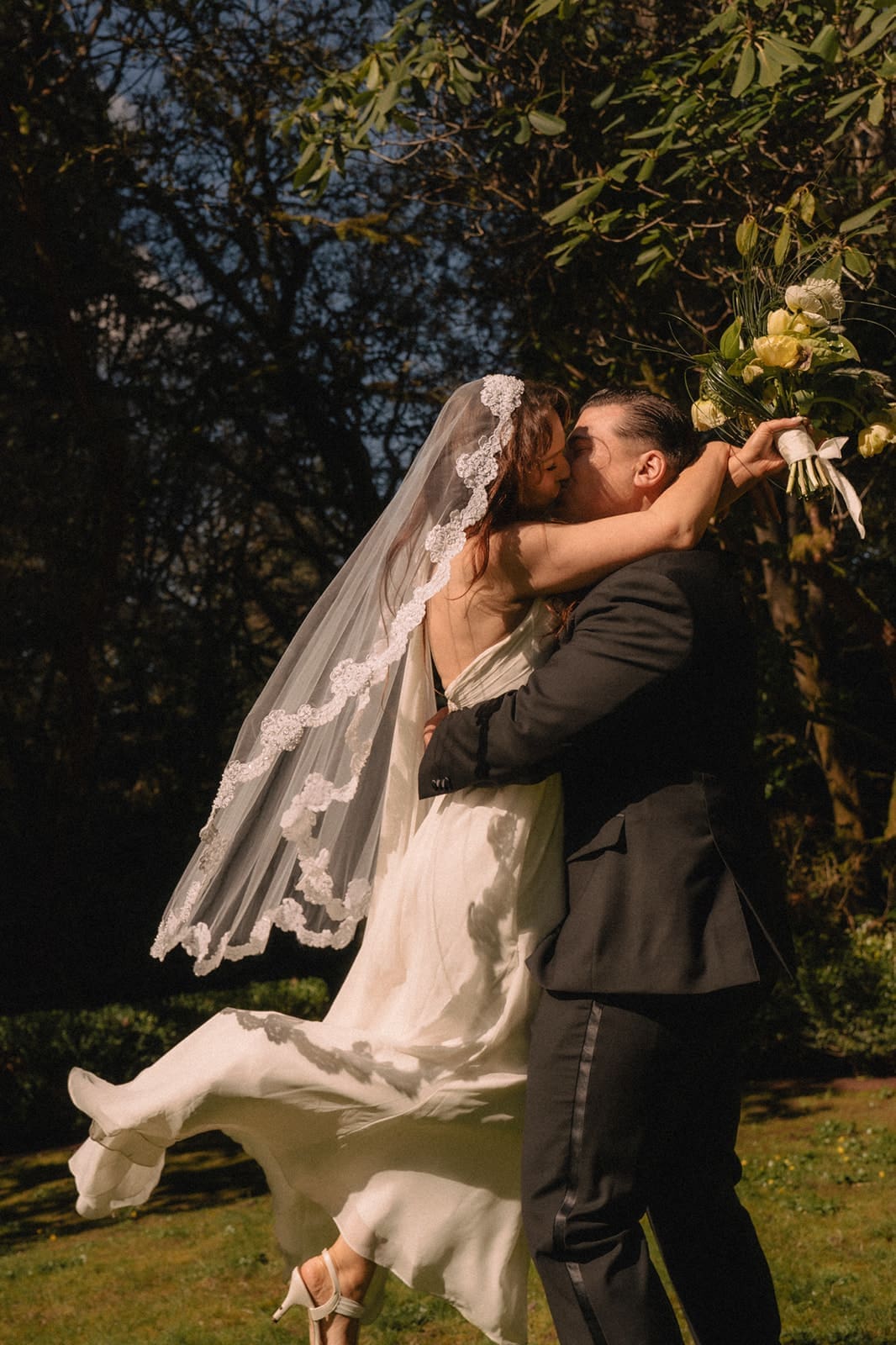 Bride and groom kissing during their Lakewold Gardens wedding photos.