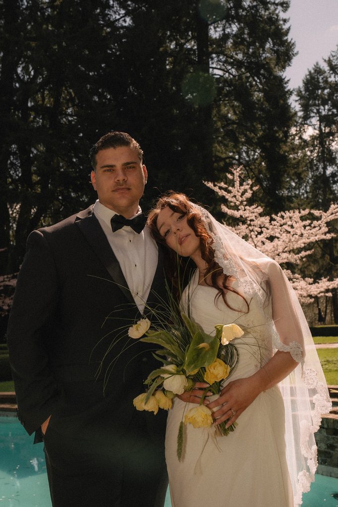 Couple posing in front of the pool for their Lakewold Gardens wedding photos in Lakewood, Washington.