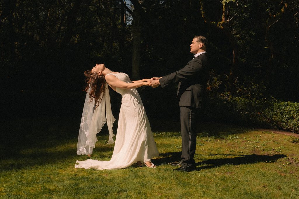Bride and groom holding hands during their romantic Lakewold Gardens wedding portraits. 