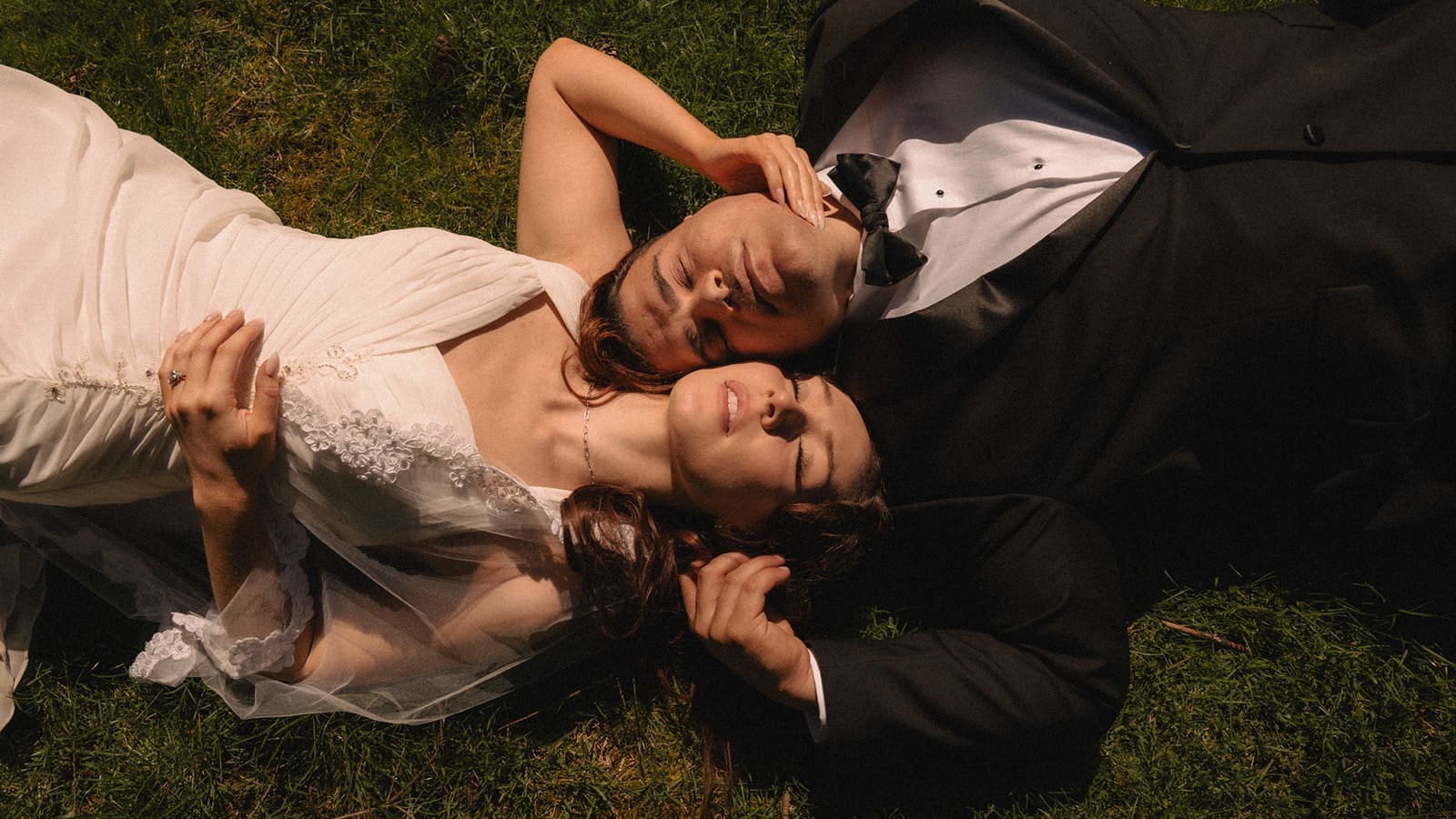 Couple laying in the grass during golden hour for their Lakewold Gardens wedding photos in Lakewood, Washington.