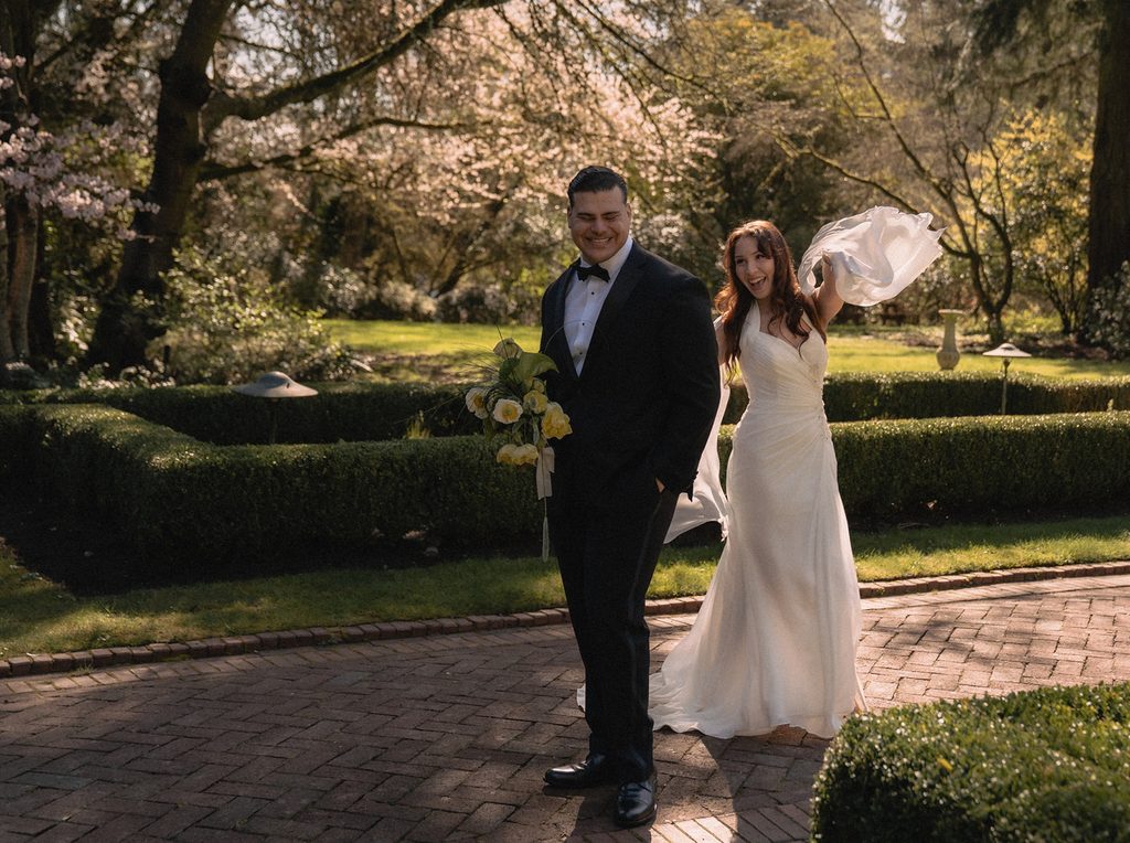 Couple being playful in the gardens at Lakewold Gardens in Lakewood, Washington. 