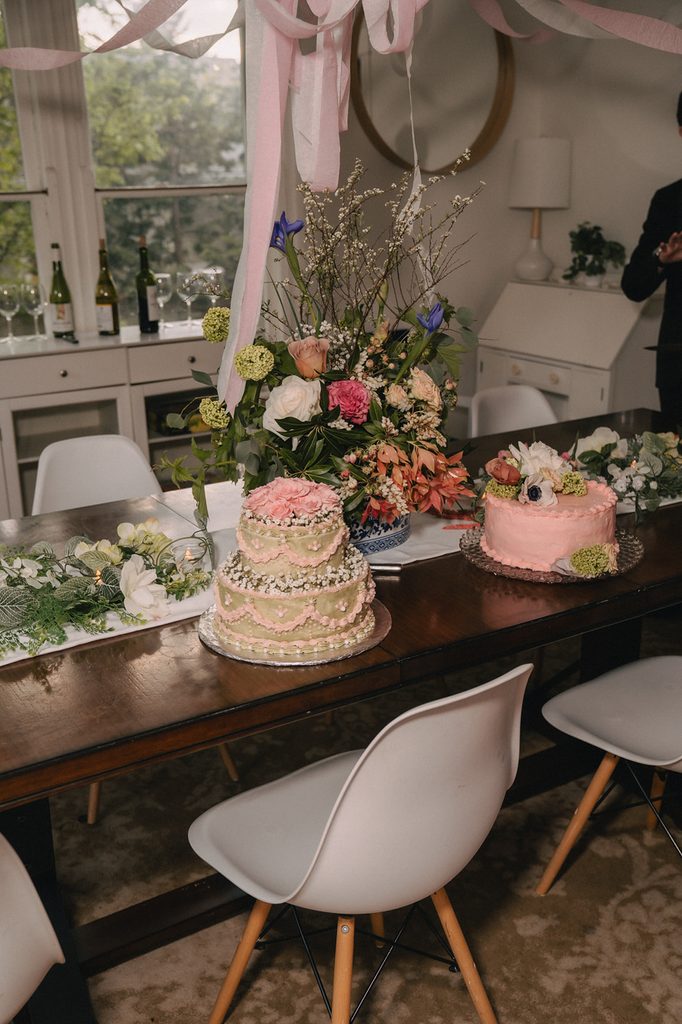 Floral wedding cakes and colorful flower arrangements on a dining table at a Seattle micro wedding