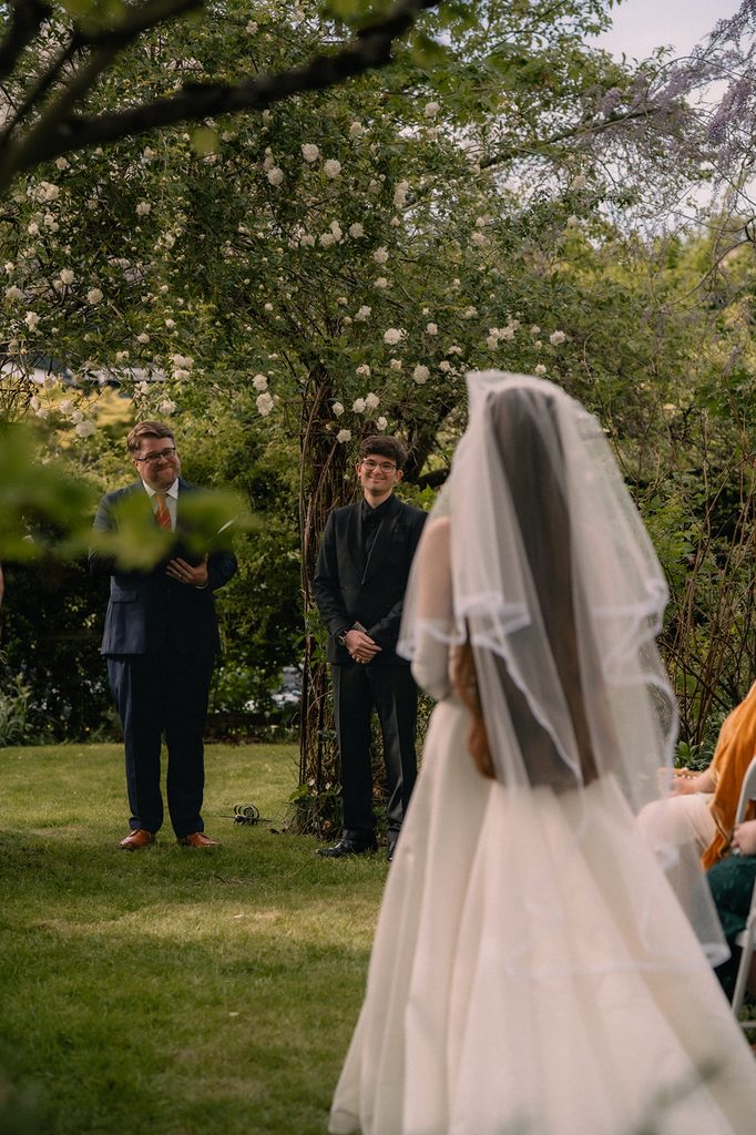 Bride walking down the aisle for her intimate Seattle micro wedding ceremony at an Airbnb.