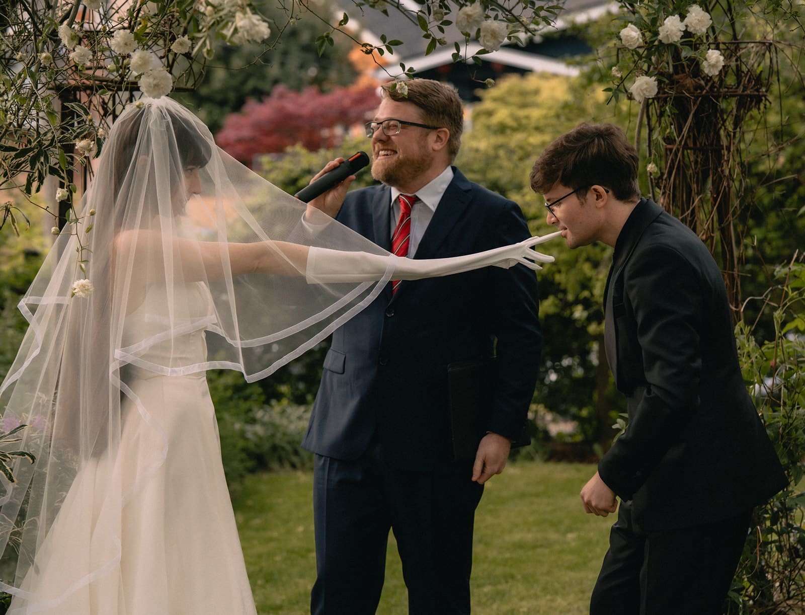 Groom taking the brides glove off during their ceremony.