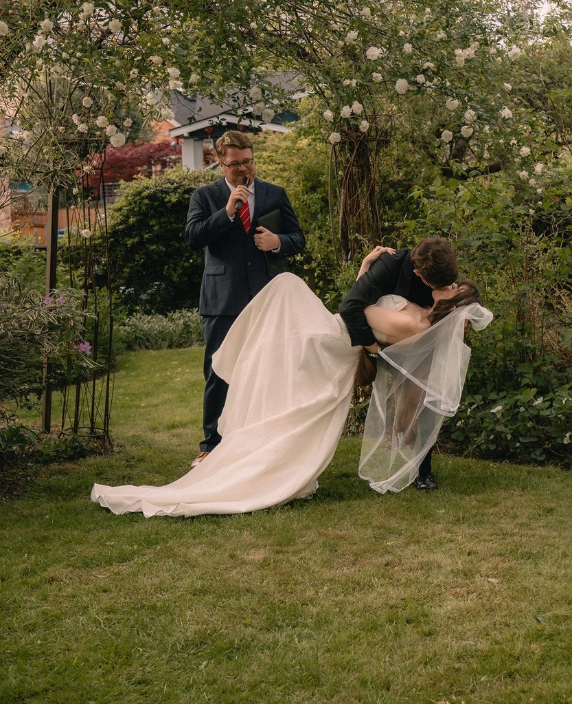 Bride and groom kissing during their Seattle micro wedding ceremony at an Airbnb.