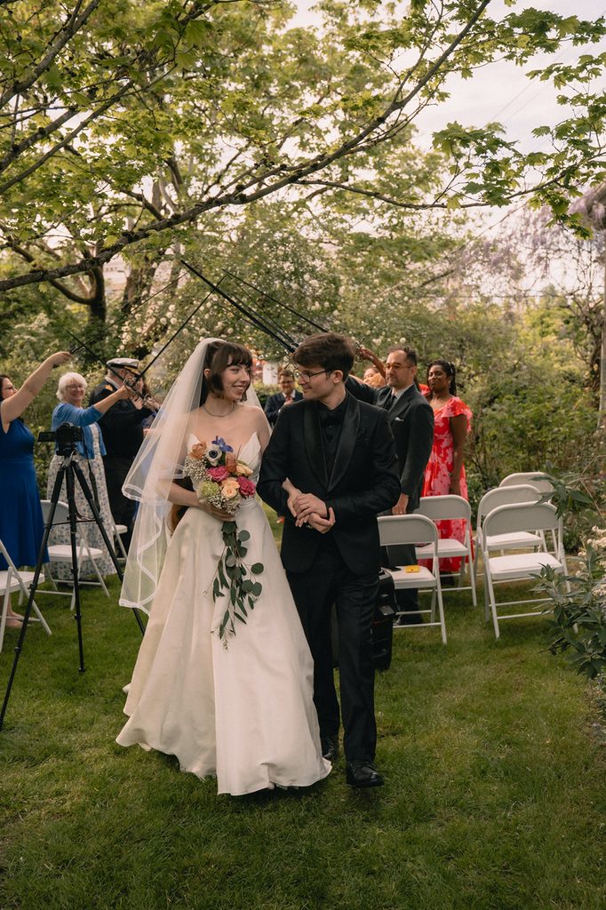 Bride and groom walking back down the aisle as husband and wife after their Seattle micro wedding ceremony at an Airbnb.