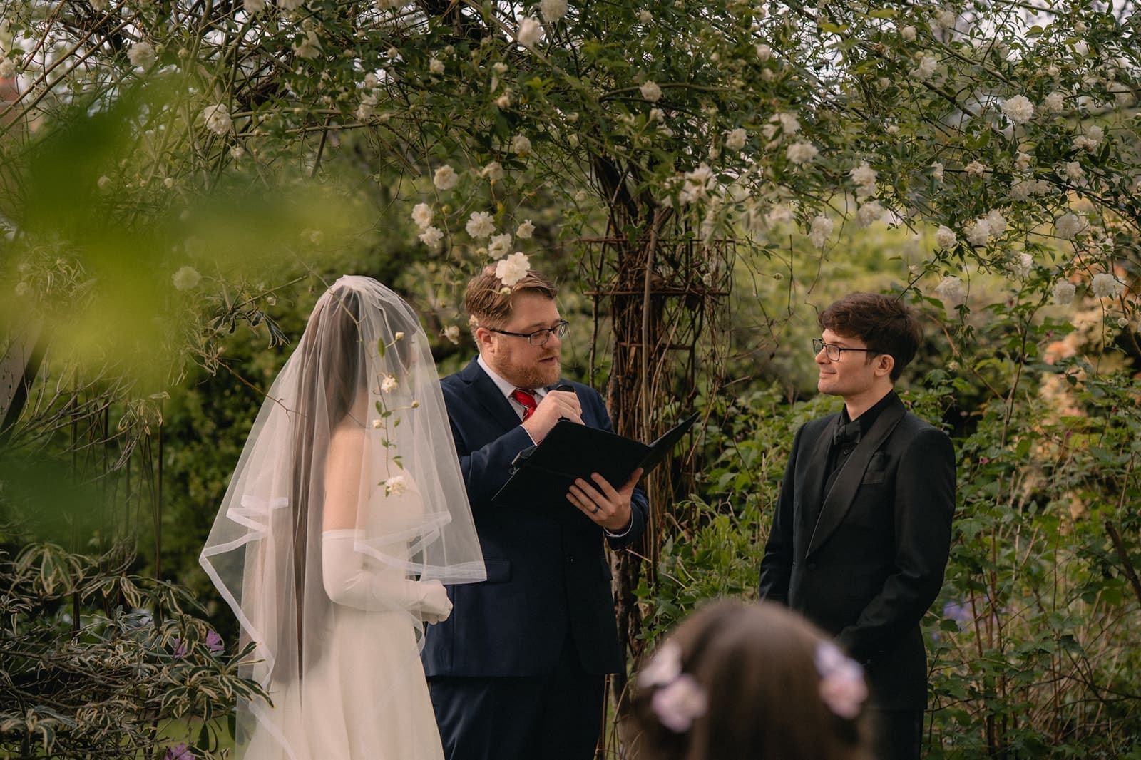 Officiant speaking during an intimate Seattle micro wedding ceremony at an Airbnb.