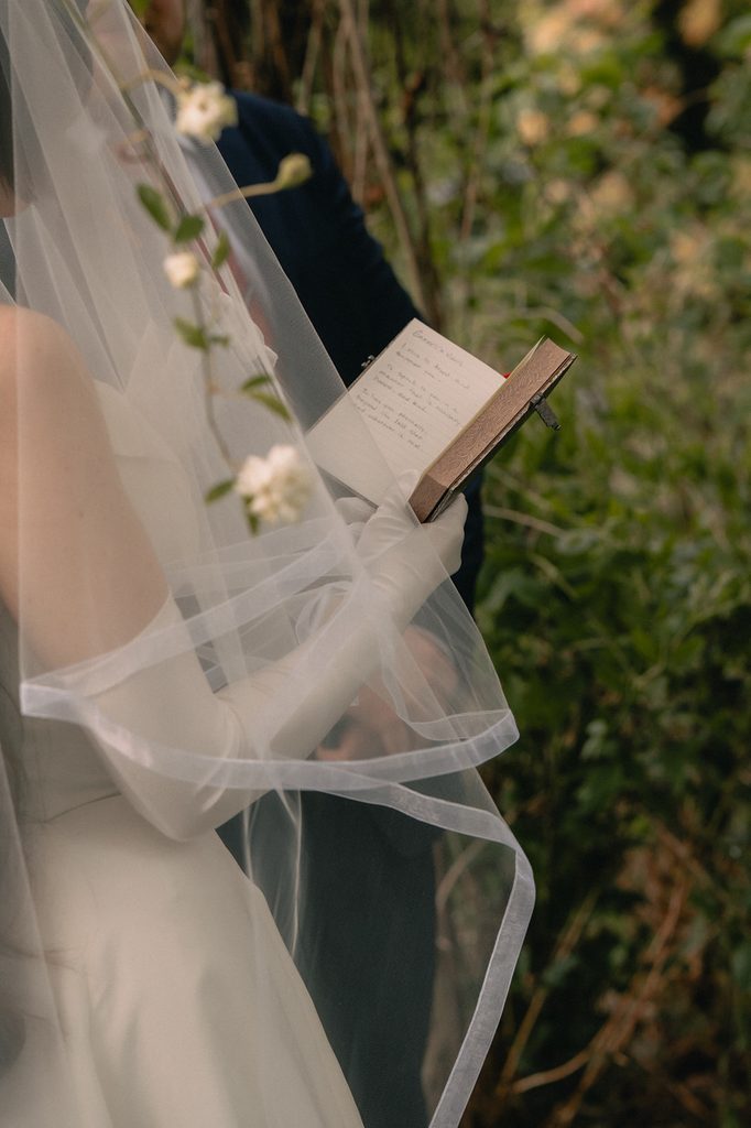 Bride reading her vows to the groom during their Seattle micro wedding ceremony at an Airbnb.