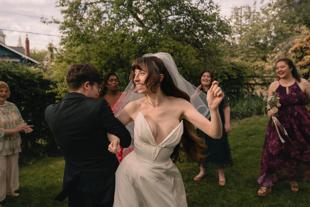 Bride and groom arm in arm dancing after their ceremony. 