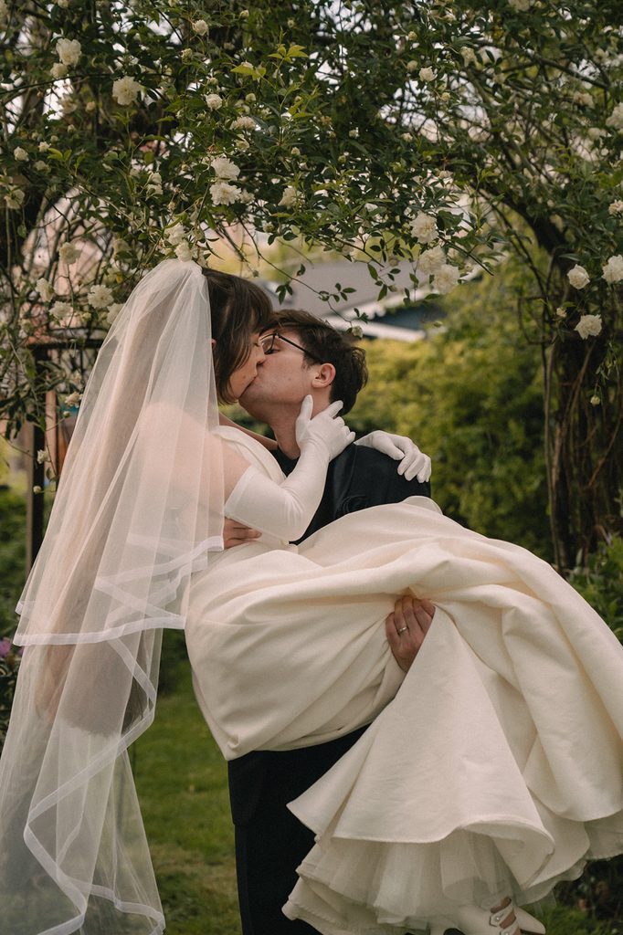 Bride and groom kissing during their outdoor portraits from a Seattle micro wedding at an Airbnb.