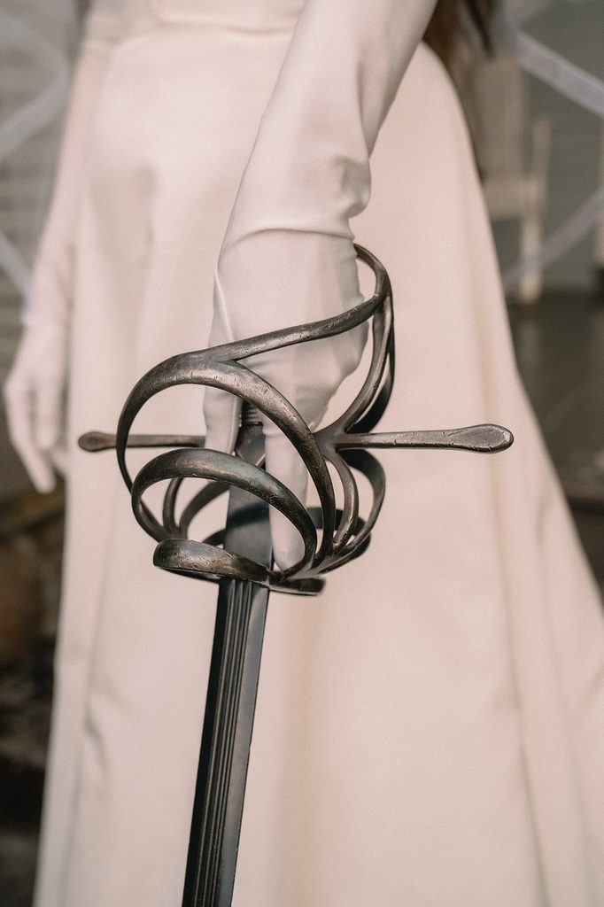 Close up shot of a bride holding a sword. 