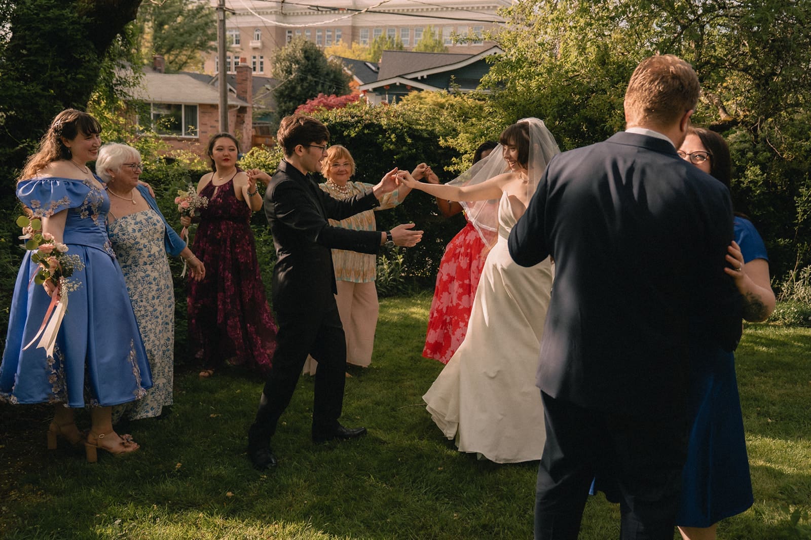 Bride and groom sharing a dance after the ceremony surrounded by family.