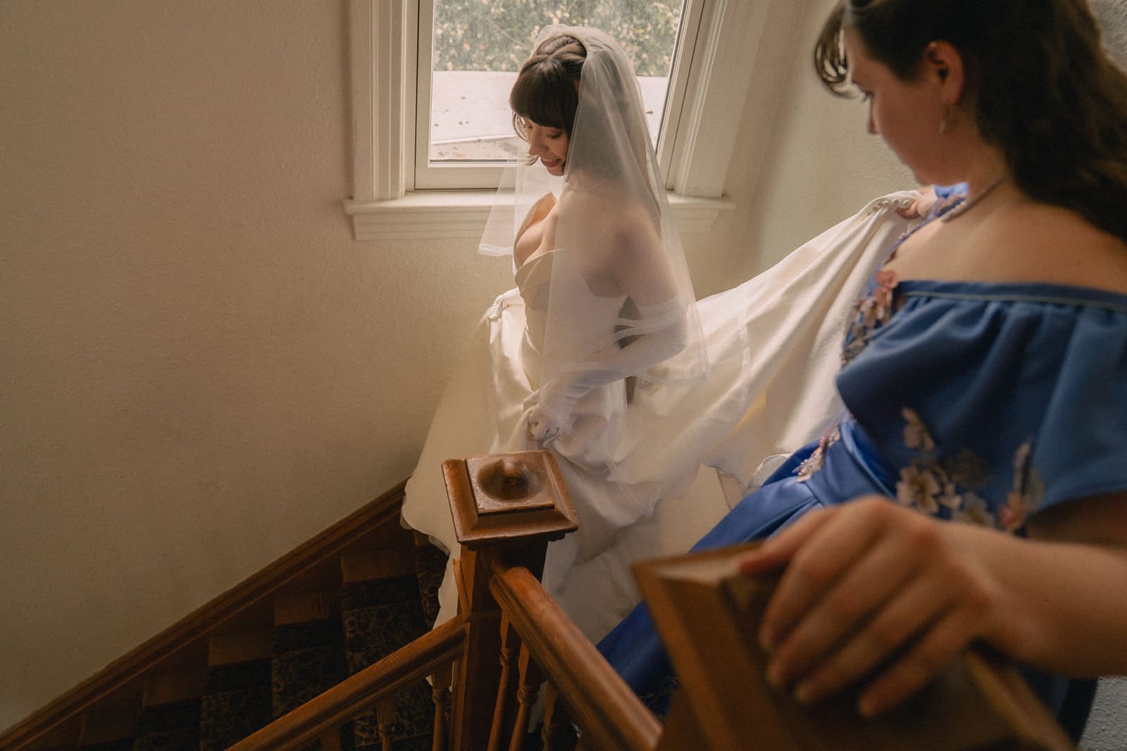 Bride walking down the stairs of an Airbnb as she heads to the backyard for their ceremony. 