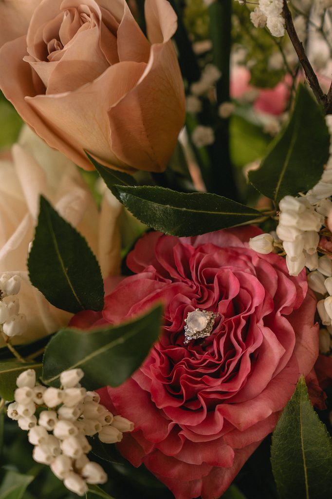 Brides wedding ring styled in her wedding bouquet.
